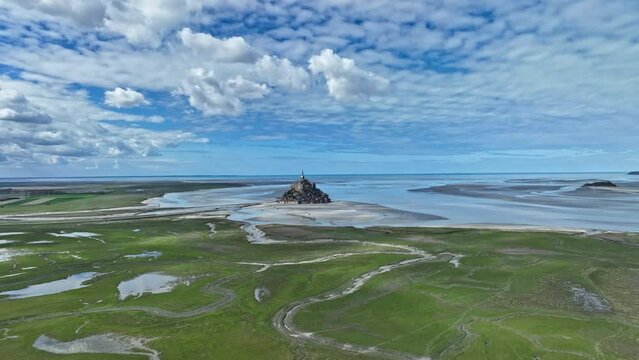 Mont Saint-Michel, seen from a drone, is a stunning island fortress in a coastal setting. 
