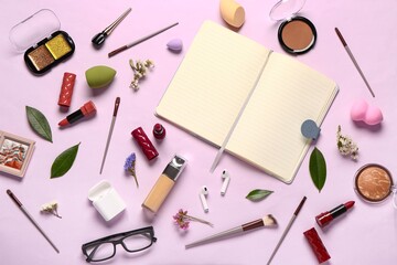 Composition with makeup cosmetics, modern earphones, eyeglasses, flowers and notebook on purple background