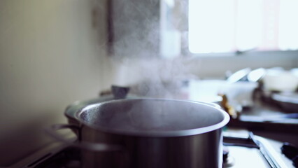Steam Rising from Metal Pan on Kitchen Stove, Cooking Process Underway