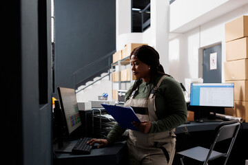Stockroom manager working at merchandise inventory, analyzing products checklist on computer in...