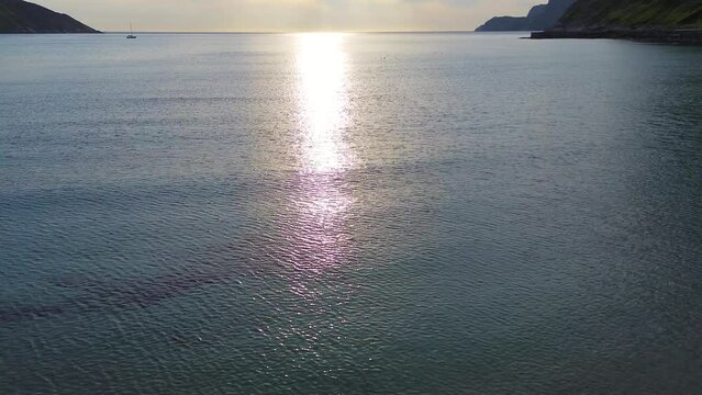 Drone flight over the ocean in the sunset. Birds and sea.  
