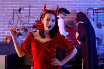 Young Asian woman in costume at Halloween party