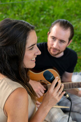 young couple playing music outdoors