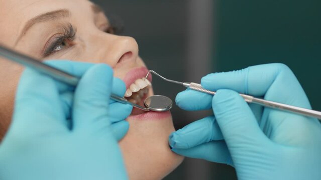Professional diagnostics in the clinic and identification of problems by a dentist. The patient knows that professional dental care helps to maintain a smile. Close-up review process