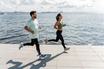 A group of friends use running shoes. Coach and client. Together athletes workout fitness. A woman...