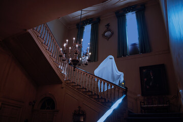Ghost going down the stairs in a hunted mansion in the evening, with a black background