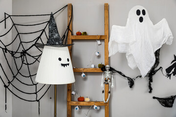 Lamp and ladder with Halloween decor in living room