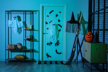 Interior of dark hall decorated for Halloween with door and shelf unit