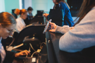 Process of checking in on a conference congress forum event, registration desk table, visitors and attendees receiving a name badge and entrance wristband bracelet and register electronic ticket