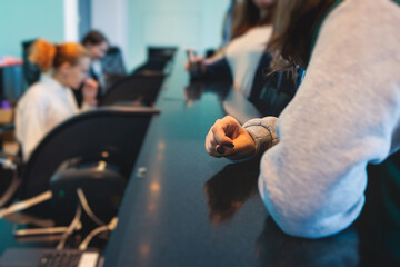 Process of checking in on a conference congress forum event, registration desk table, visitors and attendees receiving a name badge and entrance wristband bracelet and register electronic ticket