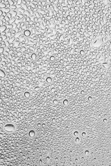water drops on the transparent surface of a glass bottle , condensation