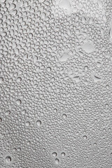 water drops on the transparent surface of a glass bottle , condensation