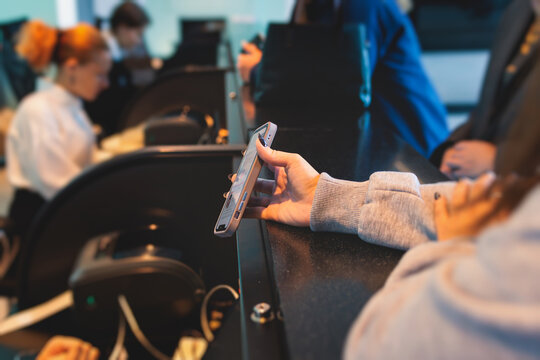 Process of checking in on a conference congress forum event, registration desk table, visitors and attendees receiving a name badge and entrance wristband bracelet and register electronic ticket
