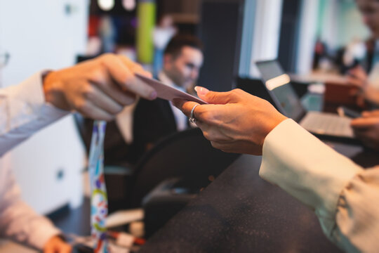 Process of checking in on a conference congress forum event, registration desk table, visitors and attendees receiving a name badge and entrance wristband bracelet and register electronic ticket