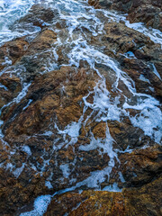 Sea foam on a rock
