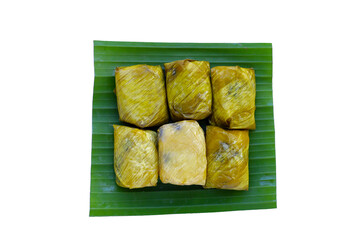 Bundled boiled sticky rice with banana and black beans wrapped in banana leaves