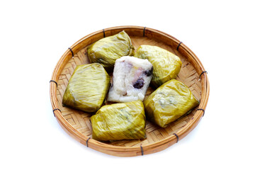 Bundled boiled sticky rice with banana and black beans wrapped in banana leaves