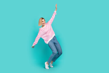 Fototapeta na wymiar Full length photo of girl raised hands up flying relaxation chill atmosphere shopping black friday party isolated on cyan color background