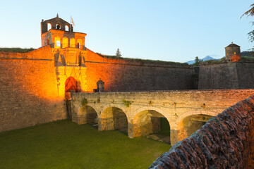 Lighted main entrance of ancient Castle of San Pedro de Jaca, Italian-style pentagram-shaped...