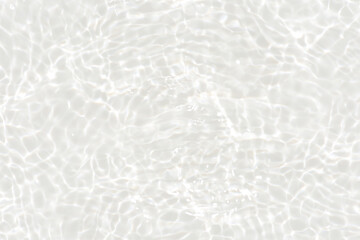 White water with ripples on the surface. Defocus blurred transparent white colored clear calm water surface texture with splashes and bubbles. Water waves with shining pattern texture background.