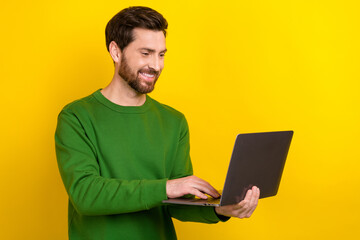 Photo of young programmer it specialist work man wear green jumper hold laptop google meet conference isolated on yellow color background