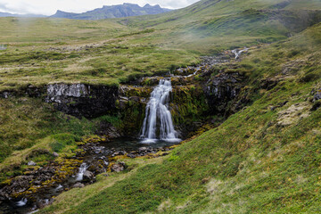 Waterfall fed by mountain streams near Grundarfjordur, Iceland