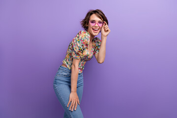 Photo of positive joyful pretty girl wear sunglass accessories rejoice enjoy good mood isolated on purple color background
