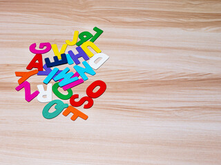 English alphabet colorful wooden for education school learning.on wood background. Alphabet concept , copy space