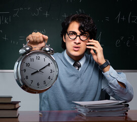 Young math teacher in front of chalkboard