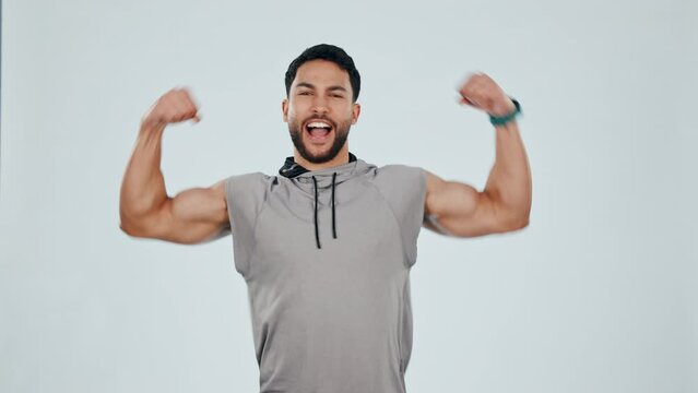 Man, face and champion, strong with muscle and fitness in studio, energy and biceps isolated on white background. Mockup space, cheers and excited for exercise, bodybuilder and strength with flexing