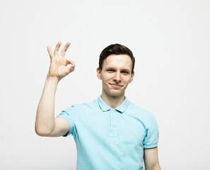 Naklejka premium young man showing ok over white background