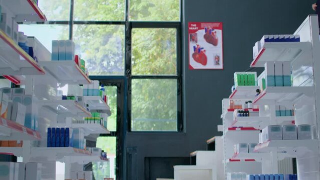 Man strolling through pharmacy getting sudden epilepsy attack, fainting and requiring medical help. Panicked customers trying to save convulsions suffering victim twitching on floor