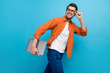 Profile photo of positive corporate agent walk hold netbook hand touch eyewear look empty space...
