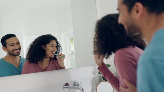 Dental, bathroom mirror reflection and happy couple brushing teeth, connect and smile for home morning treatment. Toothbrush, happiness or bonding man, woman or people cleaning mouth for oral hygiene