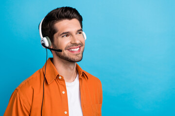 Portrait of positive cheerful person beaming smile communicate clients headset look empty space ad...