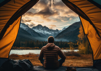 Man sitting in a tent in front of the lake and looking at the mountains. created by generative AI technology.