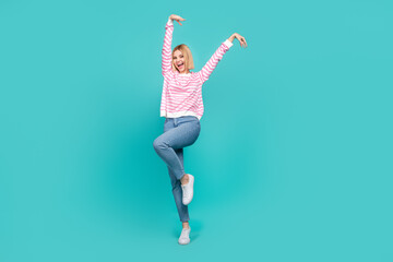 Fototapeta na wymiar Full length photo of funky adorable girl dressed striped sweater smiling having fun isolated teal color background
