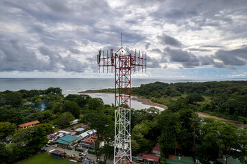 Fototapeta premium Close up aerial footage of a Cellular, telecommunications, g5 tower in the Mountain and beach of Costa Rica