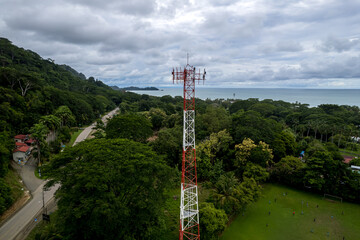 Obraz premium Close up aerial footage of a Cellular, telecommunications, g5 tower in the Mountain and beach of Costa Rica