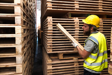 Wood  worker man working in wood factory warehouse 