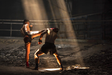 Thai boxer man kicking rival during Thai fight compition
