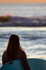 Fototapeta na wymiar surfer girl in Sunshine Coast Queensland Australia at sunrise going into the water