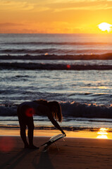 surfer girl in Sunshine Coast Queensland Australia at sunrise stretching before surfing