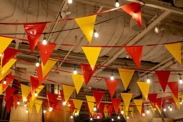 red and yellow flags in little spain restaurant - obrazy, fototapety, plakaty