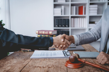 Businessman handshake to seal a deal with his partner lawyer or attorney discussing a contract agreement.