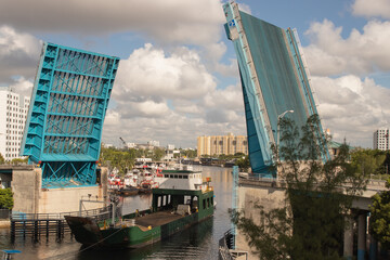 Cargo ship passing with hydraulic bridge open.