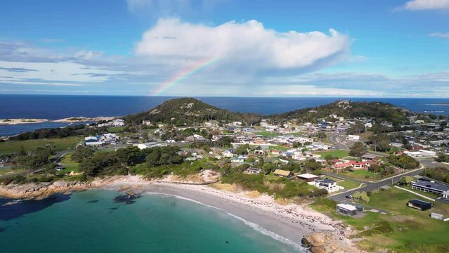 Bicheno, Tasmania: Aerial drone footage of the beach at Bicheno coastline with a rainbow close to the famous Coles bay in Tasmania in Australia. 