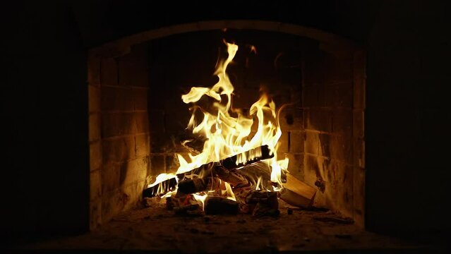 Burning Fire In The Fireplace. Slow motion. A looping clip of a fireplace with medium size flames. Cozy Relaxing Fireplace. UHD TV Screen Saver. Video for Meditation Background clip