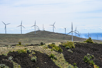 Wind turbines on a high ridge in an industrial wind farm in the dry shrub steppe climate,...