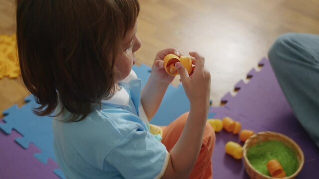 A little child enjoys learning with a caring tutor. Private education with a skilled pedagogue ensures happy progress.